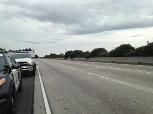 Highway patrol stopping traffic in the distance